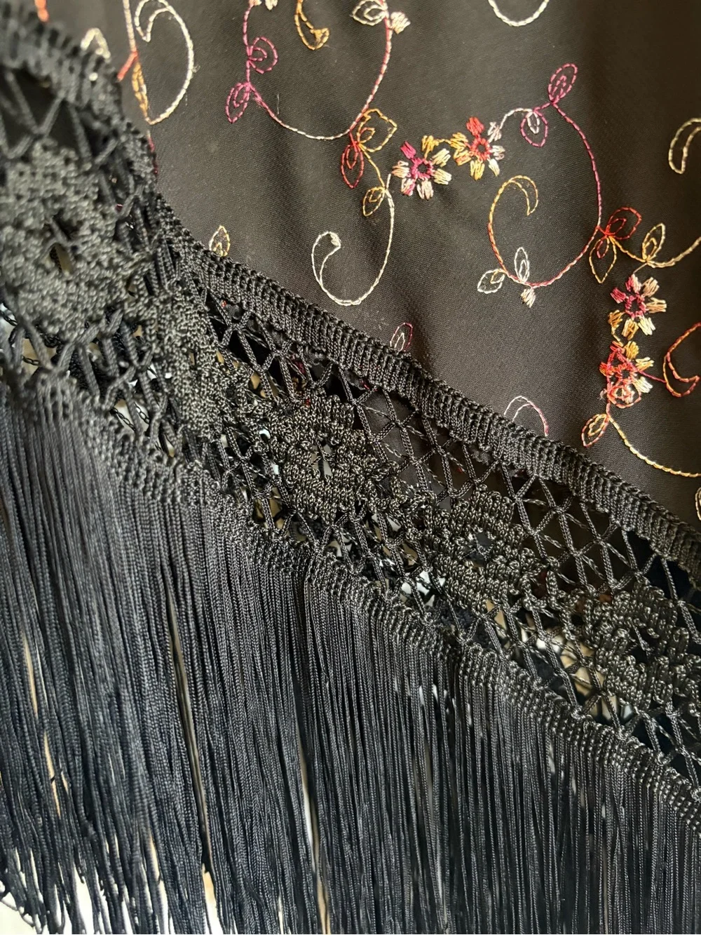 Black midi dress with floral embroidery and fringe detail